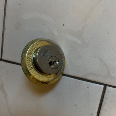 Close-up of a Lockwood lock barrel on a tiled surface.
