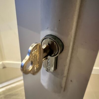 Close-up of a broken key stuck in a door lock.